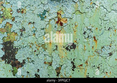 A highly detailed close-up of old distressed peeling green paint with rust texture Stock Photo