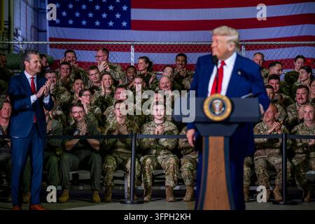 Harrison Township, United States of America. 29 April, 2025. U.S. Secretary of Defense Pete Hegseth, left, applauds as President Donald Trump delivers remarks to service members at Selfridge Air National Guard Base, April 29, 2025 in Harrison Township, Michigan. Credit: Molly Riley/White House Photo/Alamy Live News Stock Photo