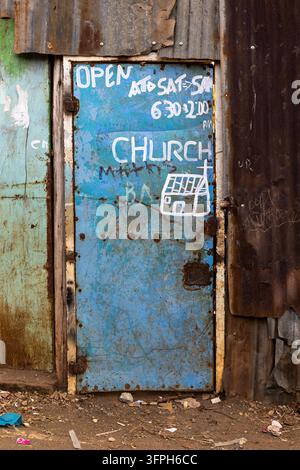 Painted blue metal door of a church entrance with white handwritten opening hours and a drawing of a church between rusty corrugated iron walls in the Stock Photo