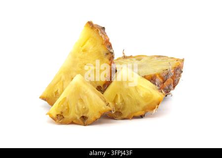 Fresh, juicy pineapple slices and wedges arranged on a clean white background. Bright yellow flesh and textured skin highlight tropical freshness, sum Stock Photo