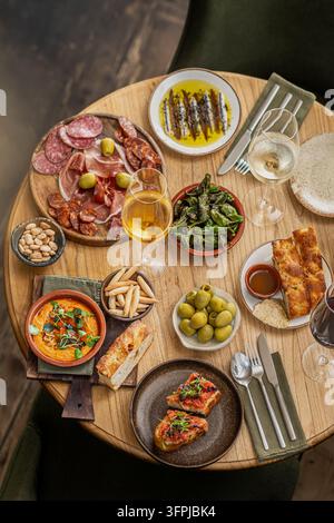 On Top Table Top view of Spanish tapas spread: croquettes with sprouts, spiced ...