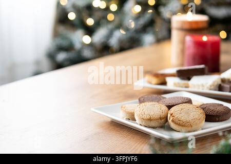 Close-up of assorted Spanish shortbread cookies, arranged on a white plate on a wooden table Stock Photo