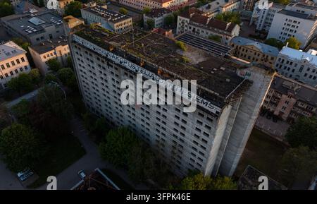 Unfinished Hotel Britanika in central Kaunas, Lithuania, showing its exposed concrete structure and the large Lithuanian word Stock Photo