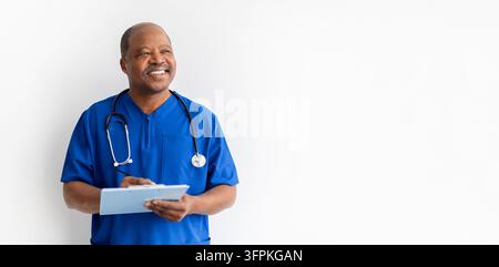 Black doctor in blue scrubs with clipboard and stethoscope on white background Stock Photo
