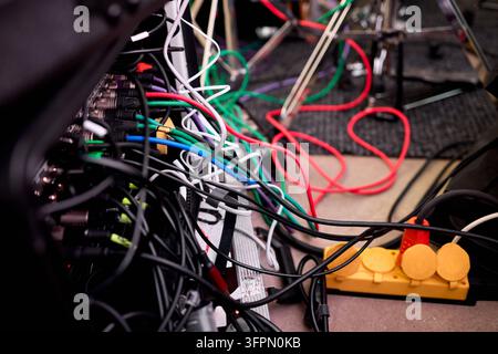 Tangled network of multicolored electrical cables and connectors Stock Photo