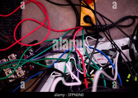 Tangled network of multicolored electrical cables and connectors Stock Photo