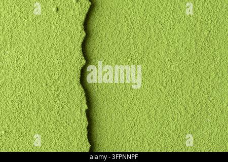 Close-up of green matcha powder with a sharp textured edge, perfect as background or mockup for clean natural product presentations. Stock Photo