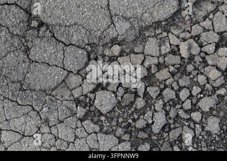A mosaic of decay: asphalt fragments break apart like tectonic plates. Stock Photo