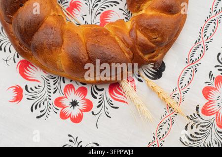 Traditional Ukrainian Christmas Bread Kalach with Wheat Ears on Embroidered Rushnyk Stock Photo