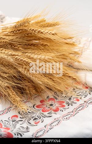 Bunch of Wheat Ears on Traditional Ukrainian Embroidered Rushnyk Stock Photo