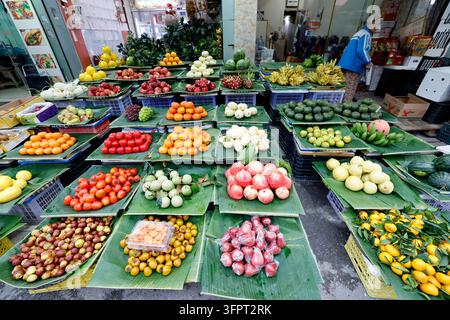 A colorful abundance of tropical fruits arranged on banana leaves at a Vietnamese market. Haiphong. Vietnam. Stock Photo