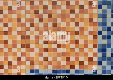 Warm Terracotta, Peach and Brown Ceramic Mosaic Tile Wall Pixel Pattern with Blue Edge Accent, Square Tiles Retro Background Stock Photo