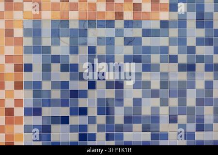 Blue Gray and Orange Ceramic Mosaic Tile Wall Pixel Pattern, Glossy Square Tiles with Warm Terracotta Border Background Stock Photo