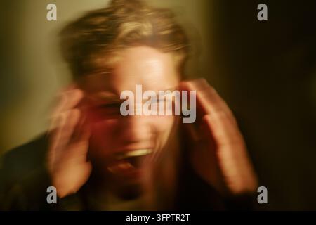 Portrait of Stressed Man Screaming in Panic and Anxiety Stock Photo