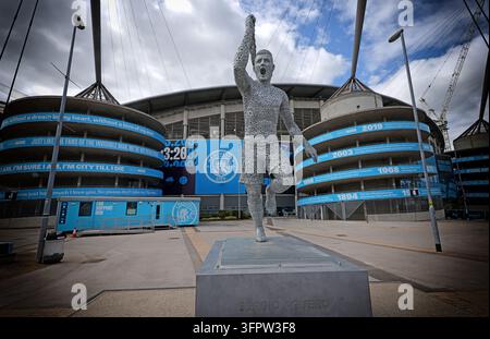 A statue of Manchester City striker Sergio Agüero celebrates his historic 93:20 winning goal outside the Etihad Stadium. Stock Photo