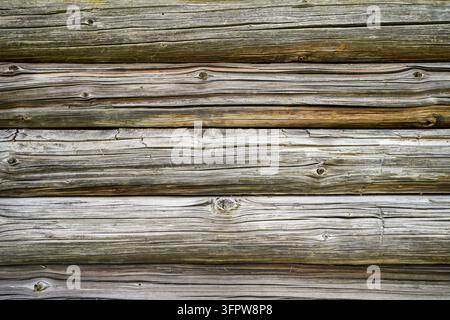 Rustic wooden wall made of weathered wooden beams. Stock Photo