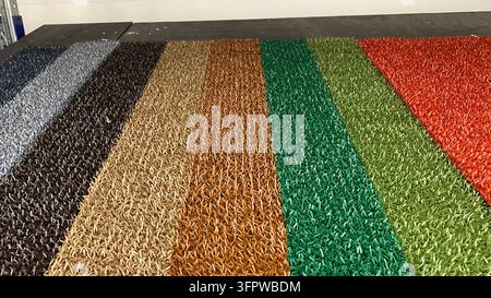 Colorful artificial grass and synthetic turf samples in different shades displayed in home improvement store. High quality photo Stock Photo