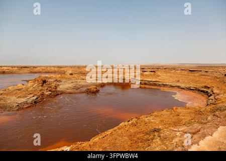 A rust colored acidic pool in the hydrothermal field of Dallol, Afar Region, Dallol, Ethiopia Stock Photo