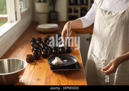 Artisan creating small batch organic body butter in a workshop Stock Photo
