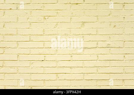 Pale yellow painted brick wall with clear brick and mortar texture Stock Photo