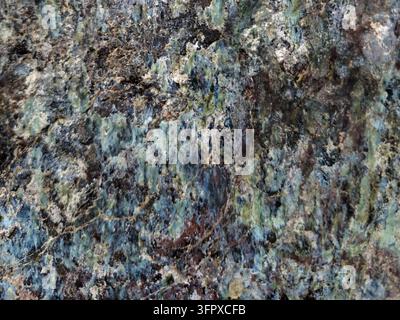 Rough natural rock texture with blue green mineral veins and crystalline patterns, detailed stone surface background perfect for organic design Stock Photo