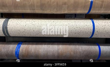 Large rolls of vinyl flooring with wood, terrazzo and stone patterns displayed at home improvement store Stock Photo