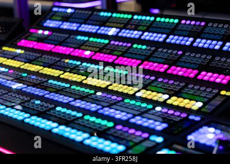 Amsterdam, Netherlands - September 11, 2026: Close view of a professional broadcast control panel featuring colorful illuminated buttons, switches, sc Stock Photo