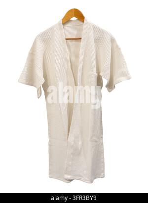 White bathrobe hanging is isolated on white background with clipping path. Stock Photo
