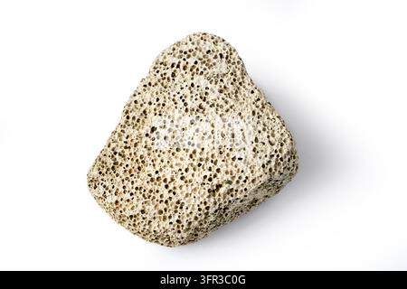 A piece of pumice stone on a white background. Porous pumice stone close-up with shadow. Stock Photo