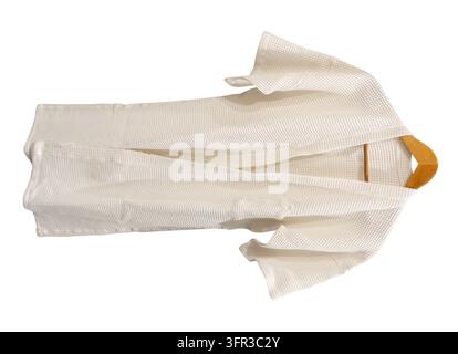 White bathrobe hanging is isolated on white background with clipping path. Stock Photo