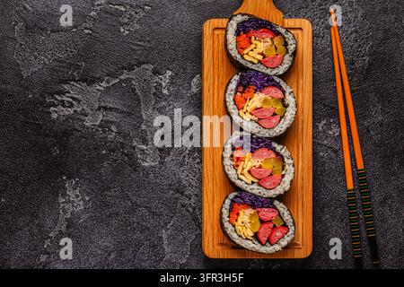 Kimbap (or gimbap) with colorful ingredients served on a wooden board Stock Photo