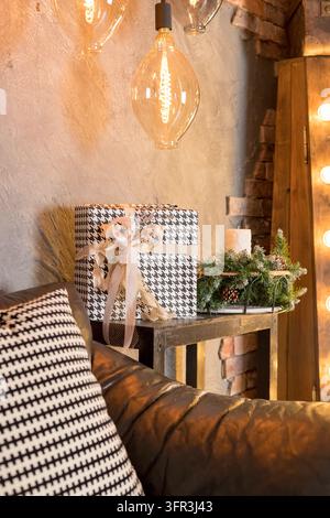 Christmas presents wrapped in checkered paper, with ribbons on the table, winter holiday concept.Minimalist Christmas holiday background with gift Stock Photo