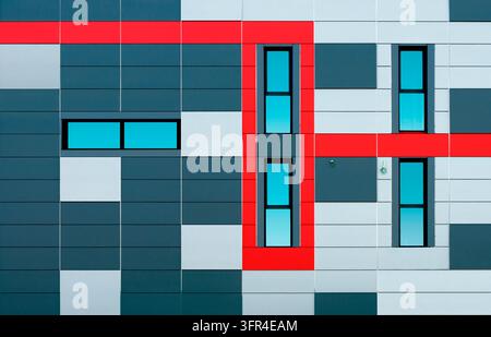 Composition of a gray and white block facade featuring five minimalist windows and a red line bordering the windows. Stock Photo