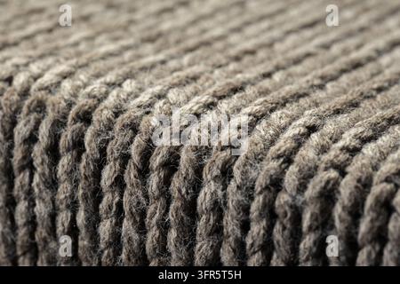 Closeup of a soft, cozy, brown ribbed knit wool fabric creating a warm, inviting textile background with detailed texture Stock Photo