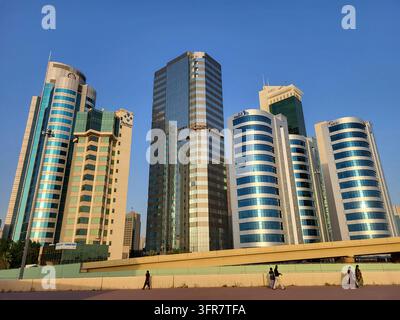Cluster of modern high-rise buildings in central Kuwait City, photographed from the Holy Family Cathedral. Against a deep blue sky, office towers line Stock Photo