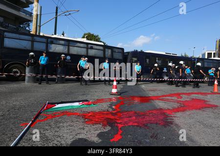 Athens, Attica, GREECE. 10th Oct, 2026. Police officers stand behind a cordon near police buses, as red paint and a Palestinian flag lie on the road during a pro-Palestinian demonstration. (Credit Image: © Harris Xanthopoulos/ZUMA Press Wire) EDITORIAL USAGE ONLY! Not for Commercial USAGE! Stock Photo