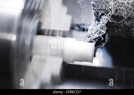 The work of a CNC lathe on a workpiece made of textolite or propylene. Automation of the production base Stock Photo