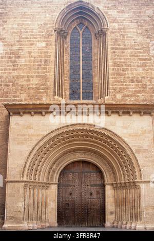 At Valenciaa, Spain, on August 2 2025.  close-up view capturing the ancient carved stone Romanesque-Gothic entrance portal, ornate archivolts, and hea Stock Photo