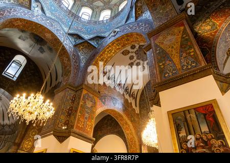 Wide view of ornately painted domes arches and crystal chandeliers inside Etchmiadzin Cathedral, Armavir Province, Etchmiadzin, Armenia Stock Photo