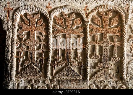Close up of carved stone crosses decorating the wall of Geghard monastery, Kotayk Province, Geghard, Armenia Stock Photo