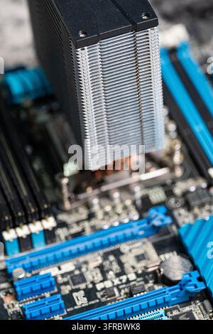 Tashkent, Uzbekistan, September 30, 2026: Close-up of a metal CPU cooling tower with copper heat pipes mounted on a computer motherboard processor soc Stock Photo