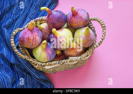 Ripe figs in small rustic basket. Space for text Stock Photo