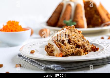 Piece of homemade carrot cake with nuts on the table in close up. Selective focus Stock Photo