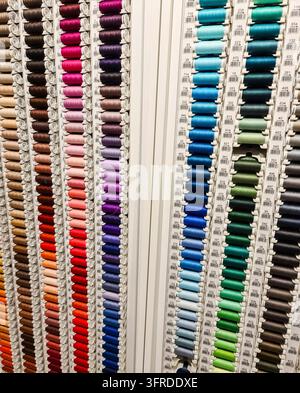 Very many colorful spools of yarn for sale in a needlework shop Stock Photo