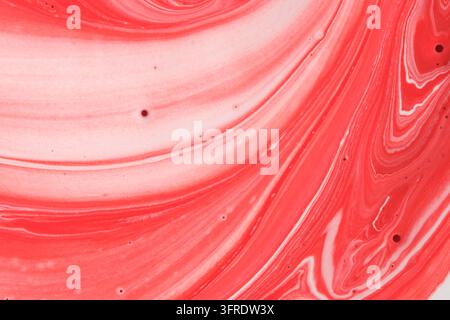 Elegant red and white fluid acrylic paint abstract background with soft swirling marble textures Stock Photo