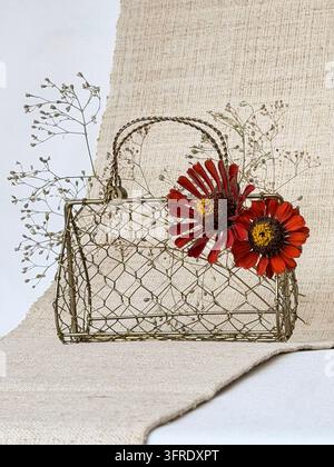 Vintage Gold Wire Handbag with Dark Orange Flowers and Dried Botanicals on Natural Linen Background with Copy Space Stock Photo