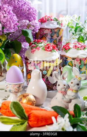Festive Easter table with Easter cakes, eggs and flowers, selective focus Stock Photo