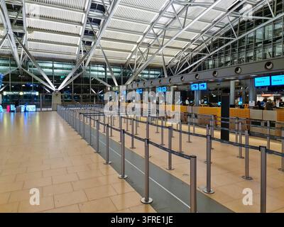 Hamburg, Germany - February 28, 2025: Steel Stanchions and Check-in Desks under Modern Architecture at Hamburg Airport Stock Photo