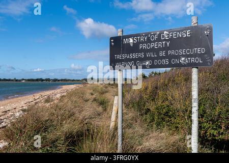 Thorney Island, West Sussex, England, UK. Ministry of Defence Property sign on the military base, Trespassers will be prosecuted. Stock Photo