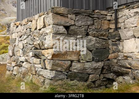 Rustic Stone Wall Built from Rough Natural Rocks and Weathered Masonry Stock Photo